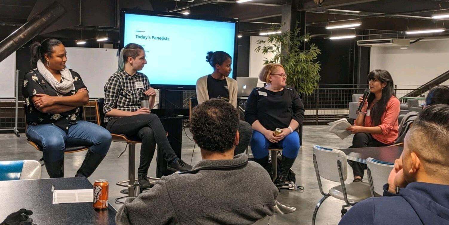 woman with computer with guests at table
